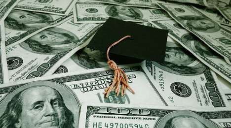 graduation cap on money