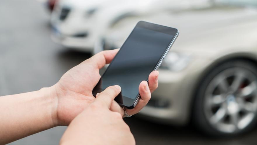 person on phone near cars_22